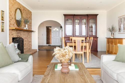 a living room with a couch and a table at Graelynn Farm in Mangrove Mountain