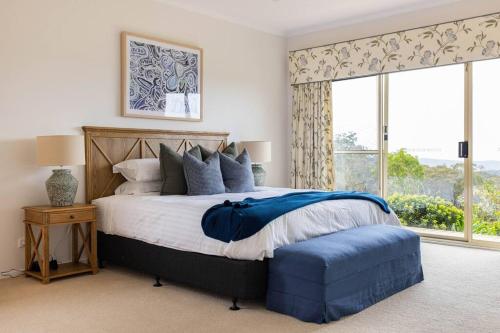 a bedroom with a large bed and a window at Graelynn Farm in Mangrove Mountain