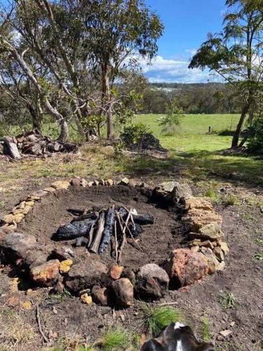 a fire pit in the middle of a field at Graelynn Farm in Mangrove Mountain