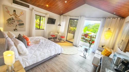 a bedroom with a bed and a large window at Rio Verde by Villa Alejandro in Boquete