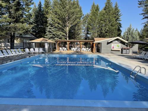 a large swimming pool with chairs and a gazebo at RidgeView Resort in Radium Hot Springs