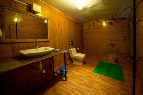 a bathroom with a sink and a toilet and a shower at La La Land Resort Goa by Spicy Mango in Palolem