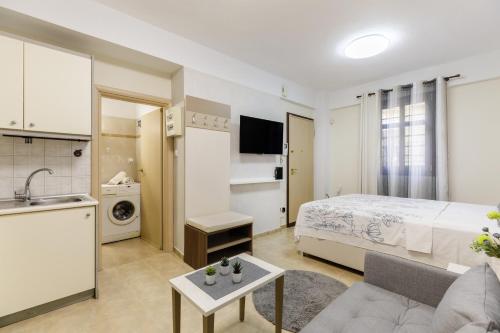 a hotel room with a bed and a kitchen at PEARL STUDIO free private parking in Thessaloniki