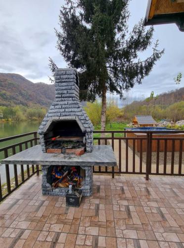 a stone oven sitting on a patio next to a fence at Vikendica Mihic in Zvornik