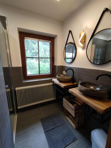 a bathroom with a sink and two mirrors at Landhaus Seebacher in Spital am Pyhrn