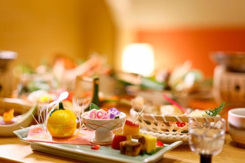 a table with a plate of food on it at Kawaguchiya Kinosaki Riverside Hotel in Toyooka