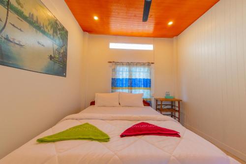 a bedroom with a bed with two towels on it at The Green Home in Siem Reap