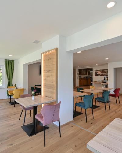 a dining room with wooden tables and chairs at Pension Freiheit in Pfronten