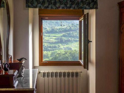 a window in a room with a radiator and a windowimum at Casa Rural Vely para 8 personas in Abándames