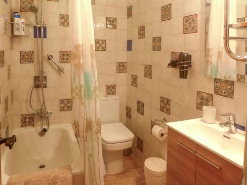 a bathroom with a tub and a toilet and a sink at Casa Rural Vely para 8 personas in Abándames