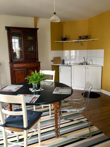 a kitchen with a dining room table and chairs at Maison Castel Braz in Pont-Aven