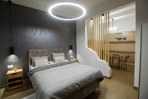 a bedroom with a large bed and a dining room at STUDIO APARTMAN BAROSSA in Vinkovci
