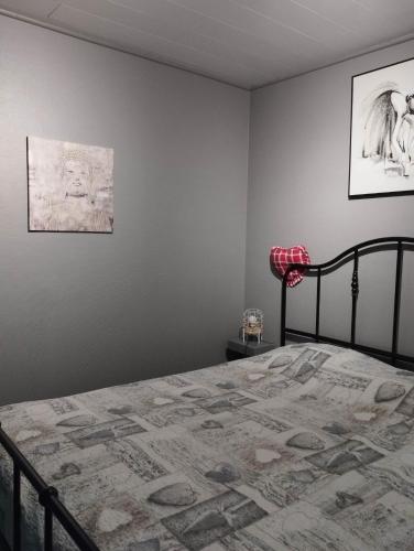 a bedroom with a bed and a picture on the wall at La chambre d Angeline in Foy-Notre-Dame