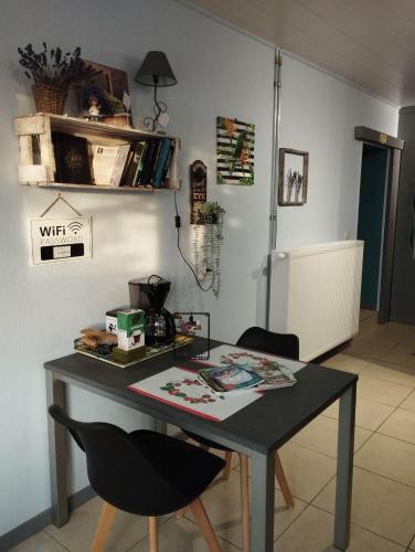 a table and two chairs in a room at La chambre d Angeline in Foy-Notre-Dame