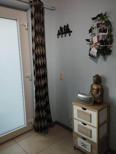 a corner of a room with a dresser and a window at La chambre d Angeline in Foy-Notre-Dame