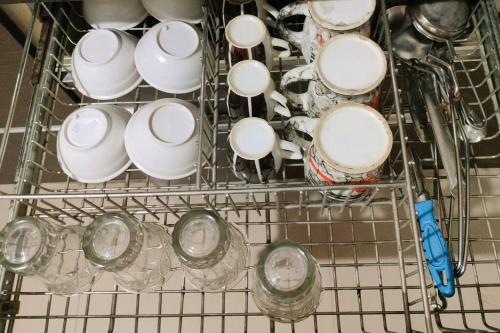 a dish rack filled with cups and plates at PORTOFINO in Lavasa