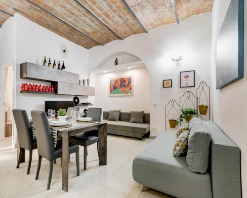 a dining room and living room with a table and chairs at Cosy Apartment- Colosseum- Termini Railway in Rome