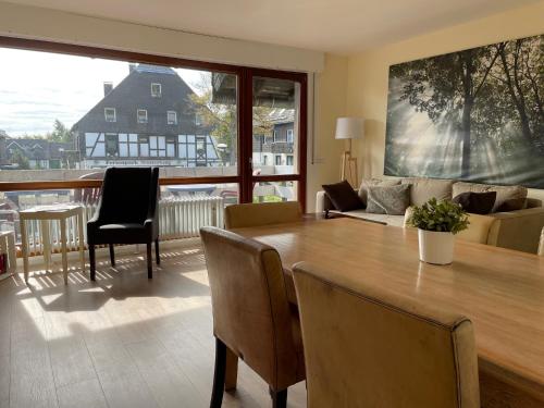 a living room with a table and a couch at Haus Merian in Winterberg