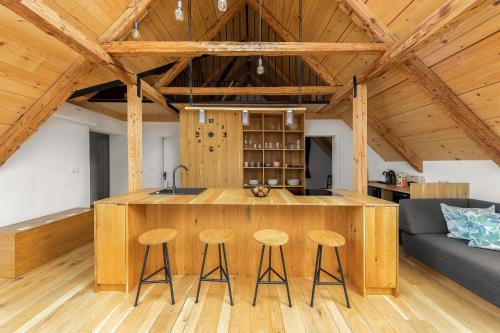 a kitchen with a large wooden island in a room at Hiša na soncu / Sun house in Zgornje Gorje