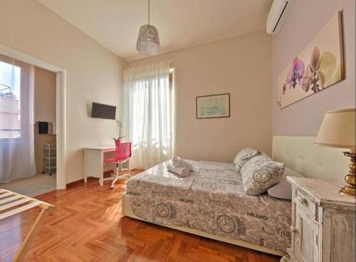 a bedroom with a bed and a desk in it at Key Apartment Vatican Wall in Rome