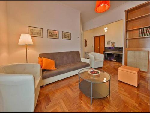 a living room with a couch and a table at Key Apartment Vatican Wall in Rome