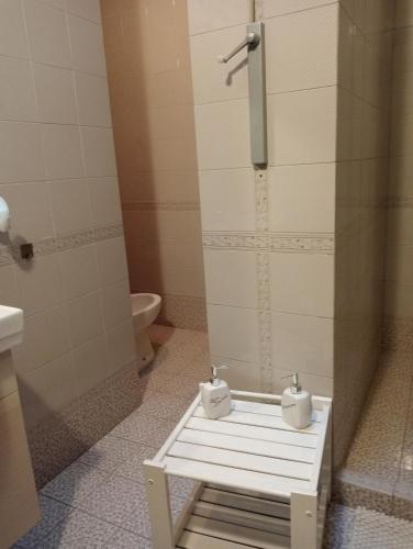 a bathroom with a shower with two toilets on a bench at A casa di Gio in Lecce