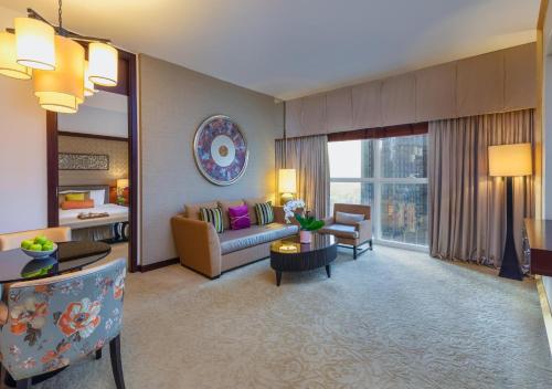a large living room with a couch and a table at Dusit Thani Dubai in Dubai
