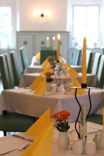 a long table with yellow napkins and candles on it at Hotel Erbgericht in Bad Schandau
