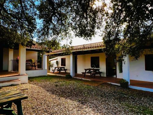 a house with a picnic table in front of it at Agriturismo Conca' e Janas in Dorgali