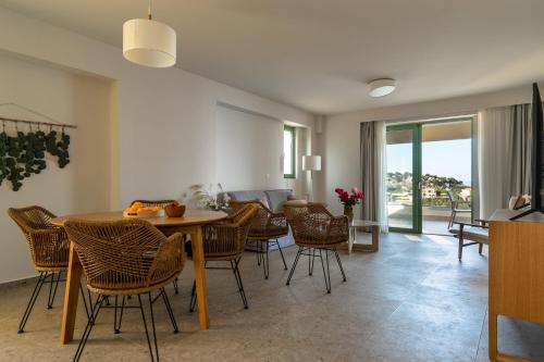 a living room with a dining room table and chairs at Joy Breeze in Kefallonia