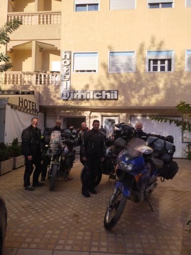 a group of men standing in front of a hotel with motorcycles at Hôtel Imilchil in Midelt