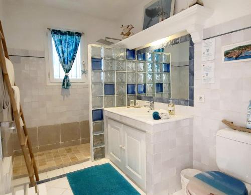 a bathroom with a sink and a toilet at Villa des Delices in Grimaud