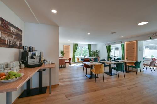 a kitchen and dining room with tables and chairs at Pension Freiheit in Pfronten