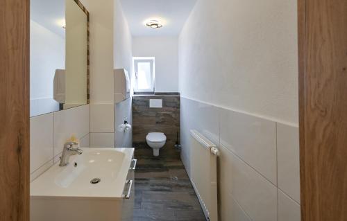 a white bathroom with a sink and a toilet at Pension Freiheit in Pfronten