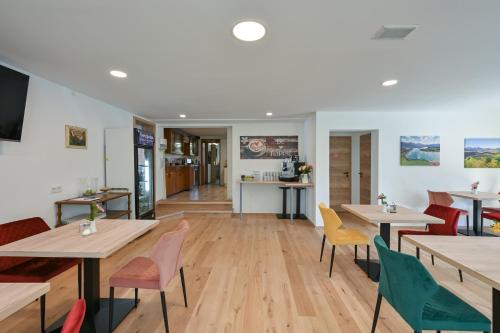 a dining room with wooden tables and chairs at Pension Freiheit in Pfronten