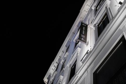 a building with a sign on the side of it at Hotel 87 eighty-seven - Maison d'Art Collection in Rome
