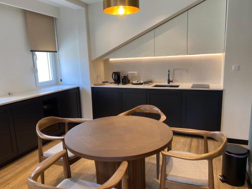 a kitchen with a wooden table and two chairs at Modern Mountain in Kolašin