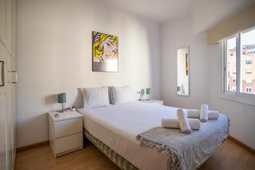 ein weißes Schlafzimmer mit einem großen Bett und einem Fenster in der Unterkunft 51flo1024 -Well located apartment in Sant Antoni in Barcelona