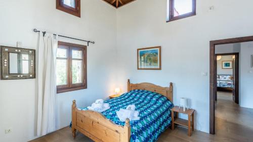 a bedroom with a bed with a blue comforter at Casa La Torre de Piedra Cañada del Real Tesoro by Ruralidays in Cañada del Real Tesoro
