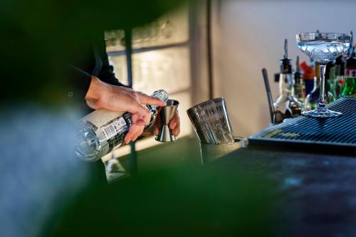 a person is holding a bottle of water on a counter at Hotel 87 eighty-seven - Maison d'Art Collection in Rome