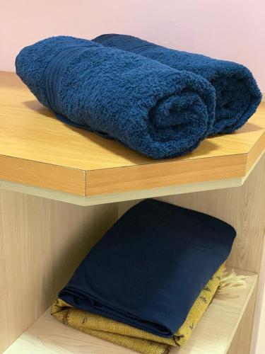 a blue towel is sitting on a wooden shelf at Sultan Bridge Place in Kota Bharu
