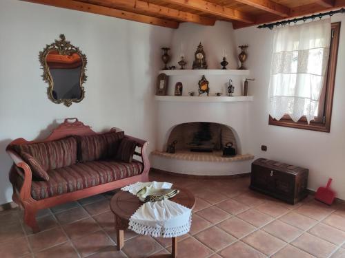 a living room with a couch and a fireplace at Villa George in Alonnisos