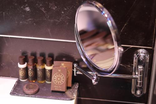 a mirror sitting next to a group of cigars at The Bryson Hotel in London