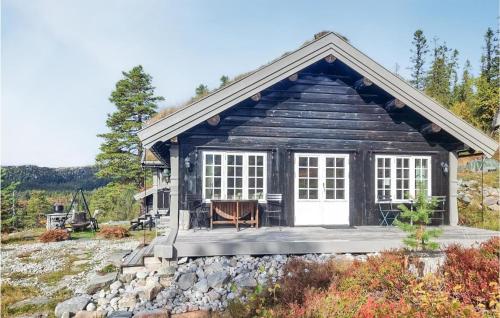 a small log cabin with a porch and white doors at 4 Bedroom Pet Friendly Home In Eggedal in Eggedal