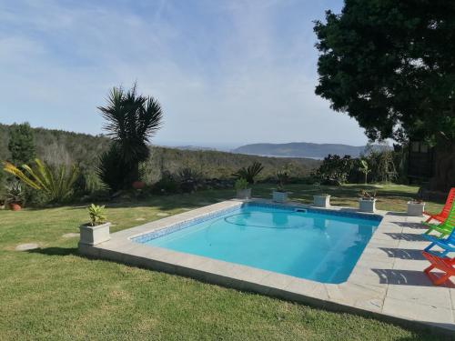 a swimming pool in the yard of a house at Knysna Tranquil 3 Bedroom Cabin in Knysna