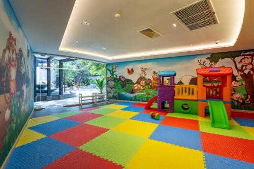a childs room with a toy train on a colorful floor at The Gems Mining Pool Villas Pattaya in Nong Prue