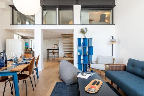 a living room with a blue couch and a table at LE M Luxueux appartement sur le Vieux port de Marseille in Marseille