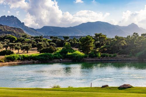 a view of a river with mountains in the background at Korineum Golf & Beach Resort in Kérynia