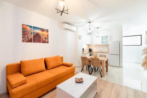 a living room with a couch and a table at Apartments & Rooms Fisherman's Luck in Vela Luka