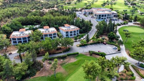 an aerial view of a resort with a park at Korineum Golf & Beach Resort in Kérynia